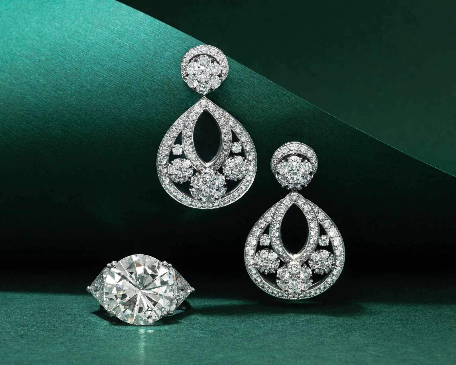 A pair of diamond earrings and a ringAI-generated content may be incorrect.