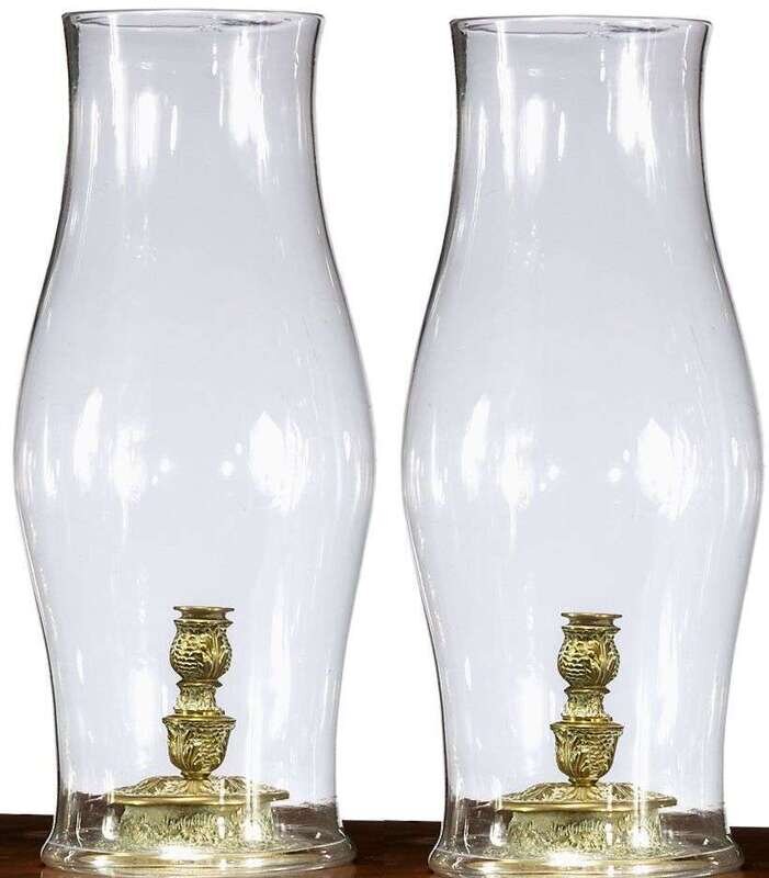 Pair of Continental brass candlesticks with blown glass hurricane
