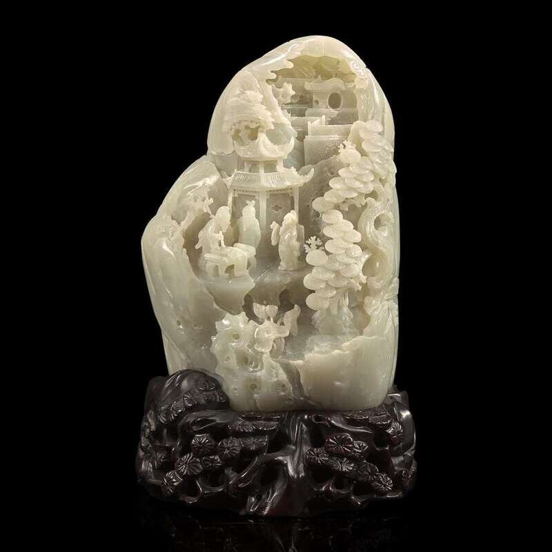 A Chinese carved greyish-white jade 